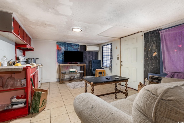 living area with light tile patterned flooring, a textured ceiling, and a wall unit AC