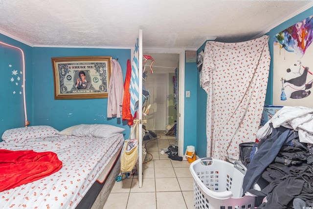 bedroom featuring tile patterned floors and a textured ceiling