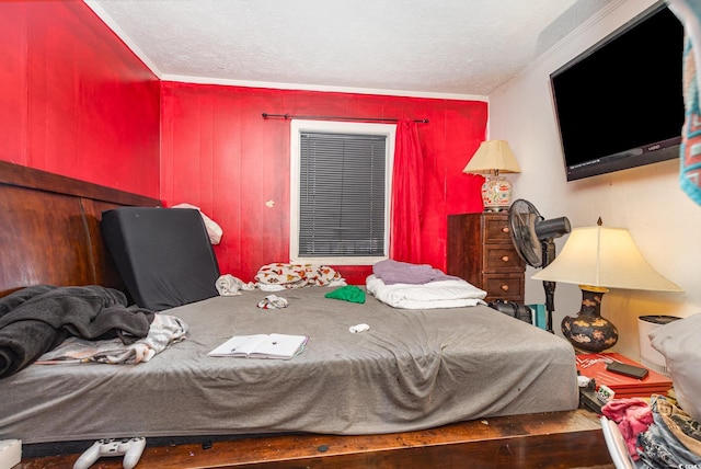 bedroom featuring crown molding and a textured ceiling