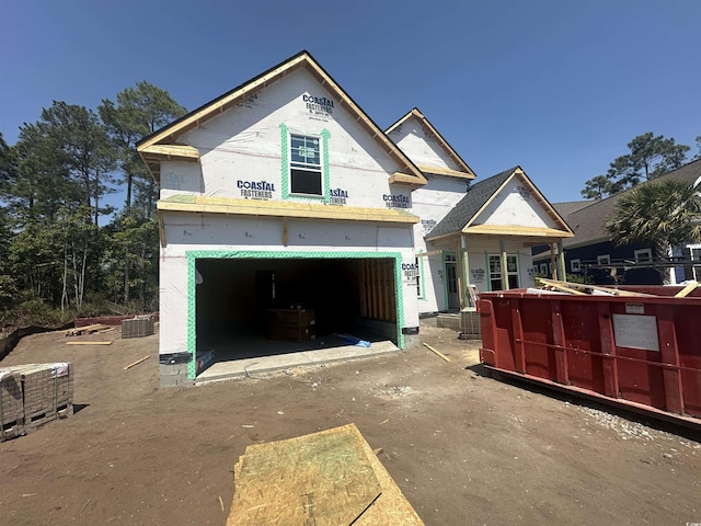 property in mid-construction featuring central air condition unit, driveway, and a garage