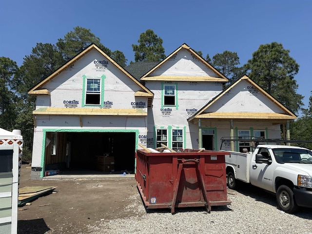 unfinished property with a garage and concrete driveway