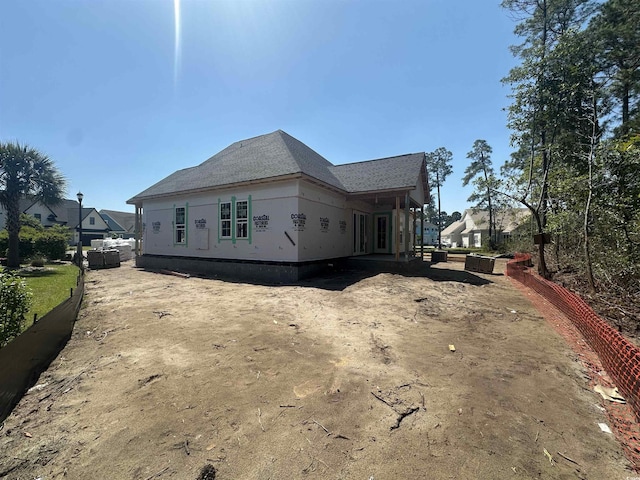 view of side of home featuring a shingled roof