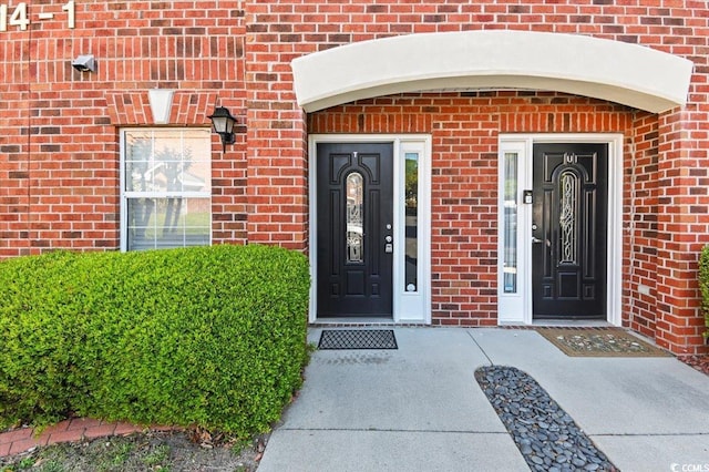 property entrance featuring brick siding
