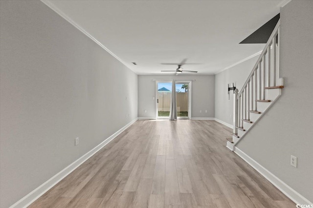 unfurnished living room with a ceiling fan, crown molding, stairway, baseboards, and light wood-style floors