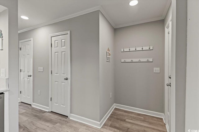 hall featuring light wood-type flooring, ornamental molding, baseboards, and recessed lighting