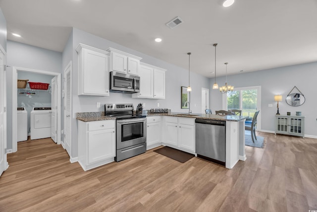 2771 Eclipse Dr, Myrtle Beach, SC 29577 - kitchen featuring appliances with stainless steel finishes, washing machine and dryer, light wood-style flooring, a peninsula, and white cabinets