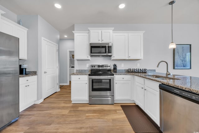 2771 Eclipse Dr, Myrtle Beach, SC 29577 - kitchen featuring stainless steel appliances, recessed lighting, white cabinetry, stone counters, and light wood finished floors