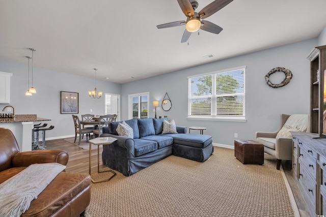 2771 Eclipse Dr, Myrtle Beach, SC 29577 - living room featuring a ceiling fan, a chandelier, and wood finished floors