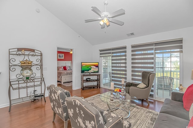 living area featuring baseboards, ceiling fan, wood finished floors, and visible vents
