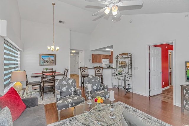 4913 Twin Pond Ct Unit 202, Myrtle Beach, SC 29579 - living area featuring visible vents, wood finished floors, high vaulted ceiling, baseboards, and ceiling fan with notable chandelier