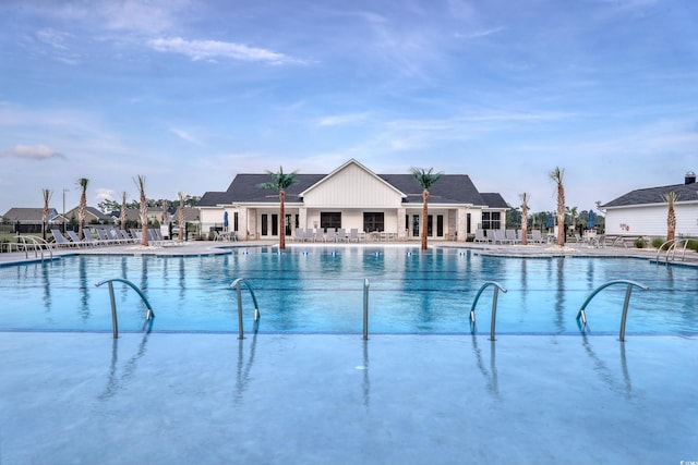 community pool featuring fence and a patio area