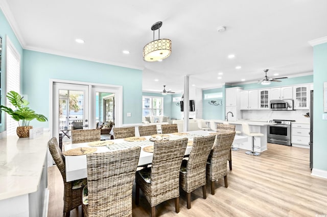 1010B S Ocean Blvd, Surfside Beach, SC 29575 - dining room featuring a ceiling fan, crown molding, light wood-type flooring, and recessed lighting