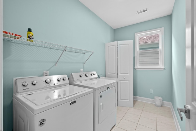 1010B S Ocean Blvd, Surfside Beach, SC 29575 - laundry room featuring washing machine and dryer, light tile patterned floors, and cabinet space