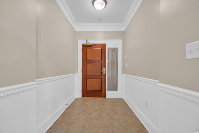 entryway featuring wainscoting, light tile patterned flooring, and crown molding