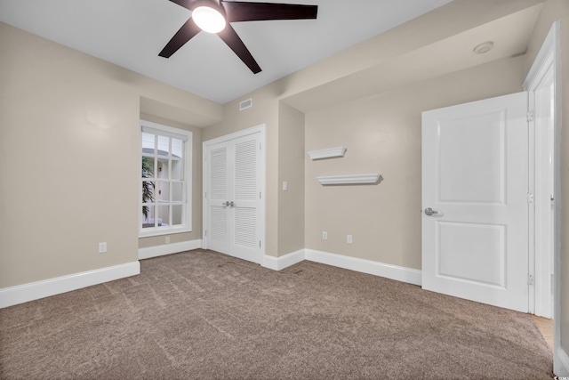 unfurnished bedroom with visible vents, carpet flooring, baseboards, and ceiling fan