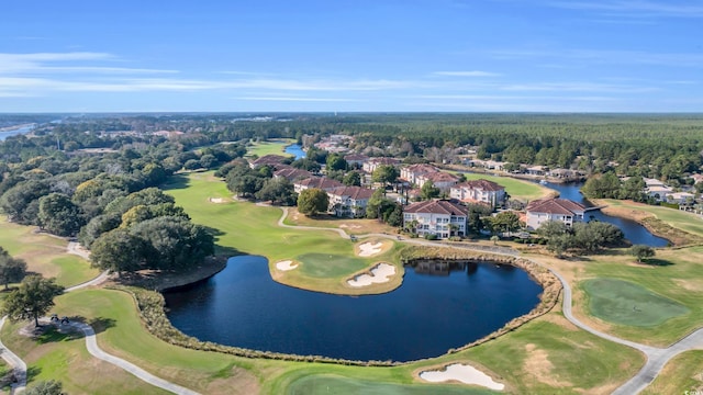 aerial view with a residential view, view of golf course, a wooded view, and a water view