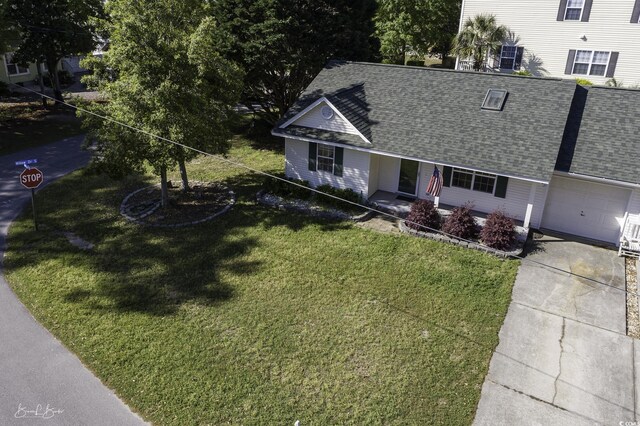 409 5th Ave S Unit 409, Surfside Beach, SC 29575 - view of front of property with roof with shingles, a garage, a front lawn, and concrete driveway