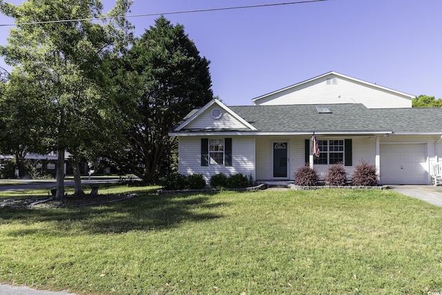 409 5th Ave S Unit 409, Surfside Beach, SC 29575 - view of front of house with an attached garage, a front lawn, concrete driveway, and roof with shingles