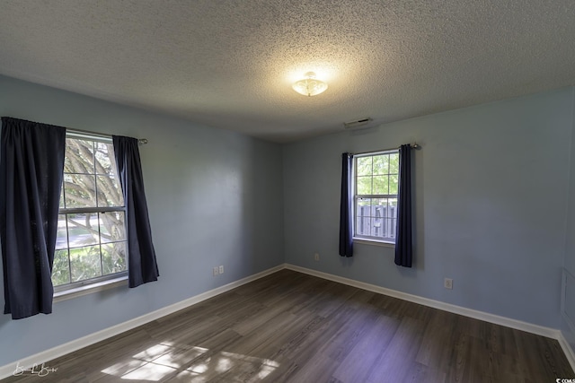 409 5th Ave S Unit 409, Surfside Beach, SC 29575 - unfurnished room with a textured ceiling, dark wood-type flooring, and baseboards
