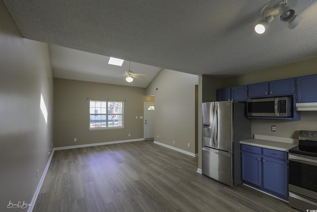 409 5th Ave S Unit 409, Surfside Beach, SC 29575 - kitchen featuring appliances with stainless steel finishes, blue cabinets, ceiling fan, light countertops, and a textured ceiling