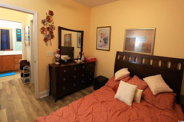 110 Portsmith Dr Unit 8, Myrtle Beach, SC 29588 - bedroom with wood finished floors and connected bathroom