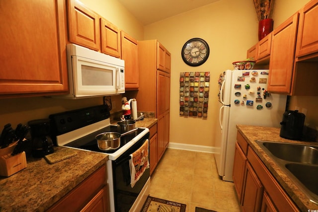 110 Portsmith Dr Unit 8, Myrtle Beach, SC 29588 - kitchen featuring white microwave, electric range, a sink, baseboards, and brown cabinets