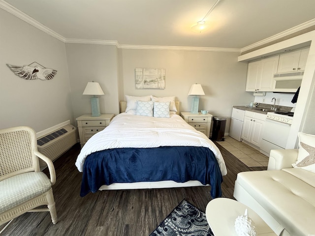 2001 S Ocean Blvd S Unit 511, Myrtle Beach, SC 29577 - bedroom with a sink, ornamental molding, a wall mounted AC, and light wood-style flooring