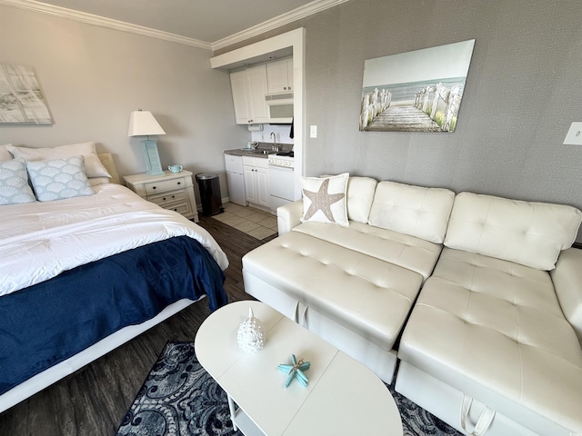 2001 S Ocean Blvd S Unit 511, Myrtle Beach, SC 29577 - bedroom featuring baseboards, ornamental molding, a sink, and light wood-style flooring