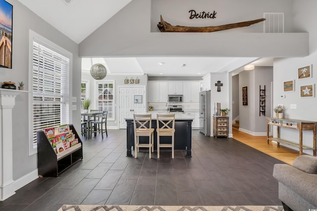 dining area featuring recessed lighting, high vaulted ceiling, visible vents, and baseboards