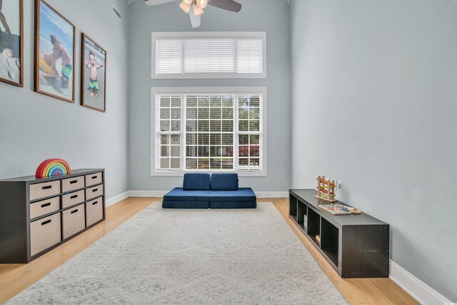 3300 Prioloe Dr, Myrtle Beach, SC 29588 - living area featuring a ceiling fan, light wood-style floors, and a high ceiling