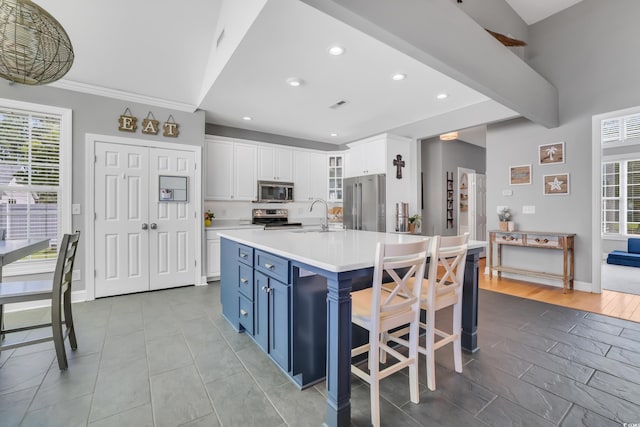 kitchen featuring light countertops, appliances with stainless steel finishes, plenty of natural light, and recessed lighting