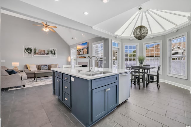 kitchen with a sink, dishwasher, light countertops, open floor plan, and vaulted ceiling