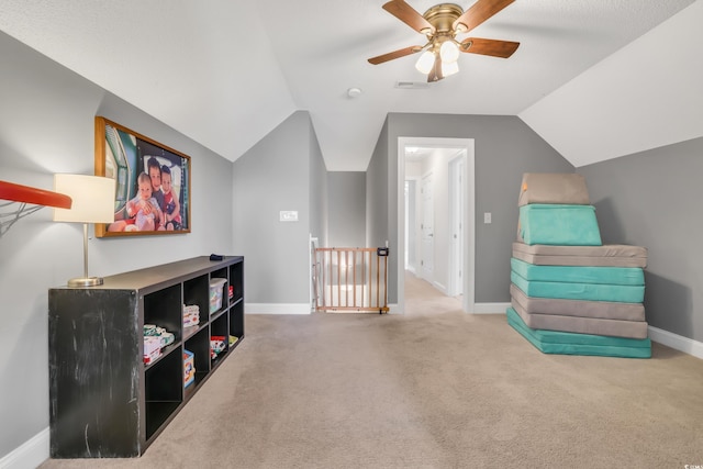 sitting room with baseboards, a ceiling fan, lofted ceiling, and carpet flooring