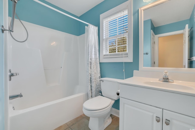 bathroom featuring tile patterned flooring, shower / bath combo, vanity, toilet, and baseboards
