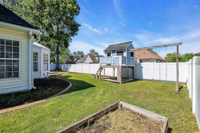 view of yard featuring a garden and a fenced backyard