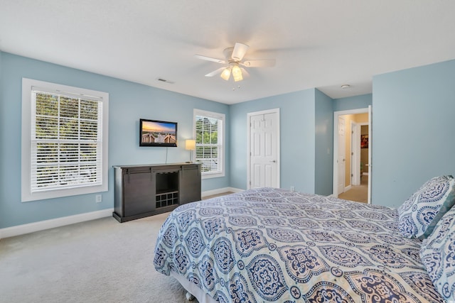 carpeted bedroom featuring a ceiling fan, baseboards, visible vents, and a closet
