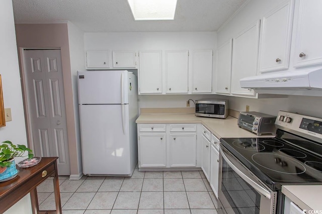 kitchen featuring stainless steel appliances, a toaster, white cabinetry, light countertops, and under cabinet range hood