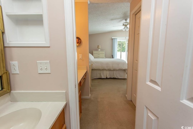 bathroom with vanity, a textured ceiling, and ceiling fan