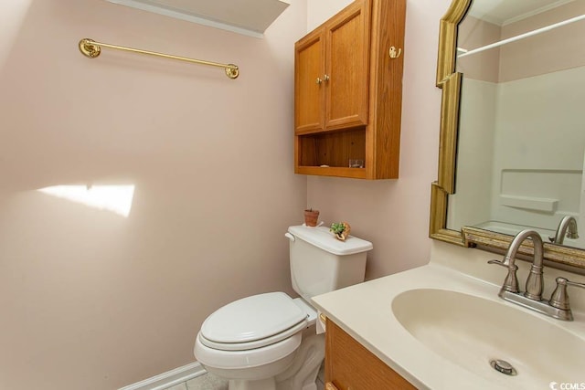 bathroom with crown molding, vanity, and toilet