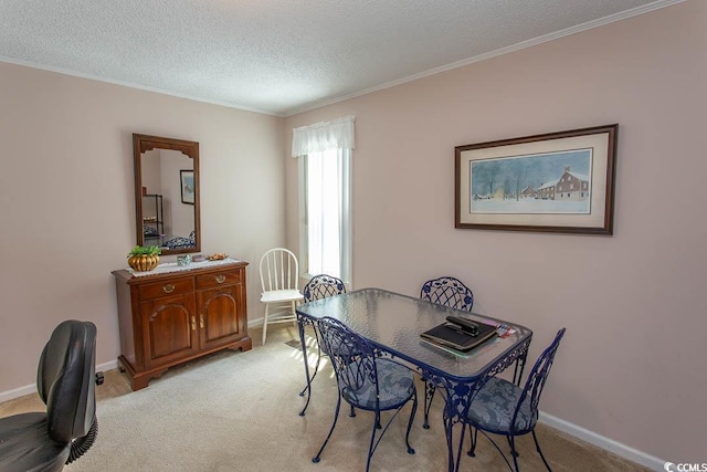 dining space featuring light carpet, crown molding, a textured ceiling, and baseboards