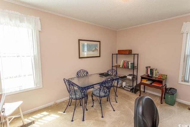 dining space with light carpet, baseboards, and ornamental molding