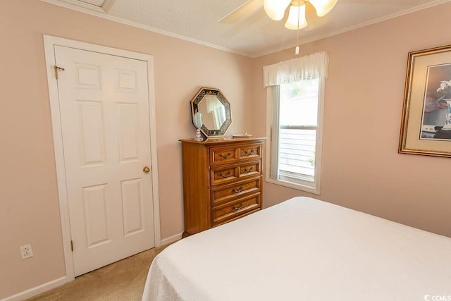 bedroom featuring a ceiling fan, light carpet, and crown molding