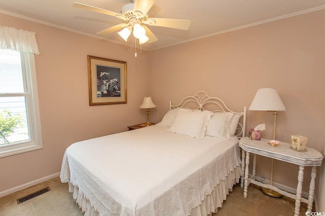 bedroom with baseboards, visible vents, crown molding, and light colored carpet