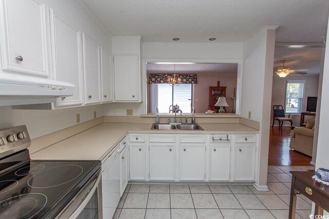 kitchen featuring a sink, a textured ceiling, electric stove, under cabinet range hood, and light tile patterned floors