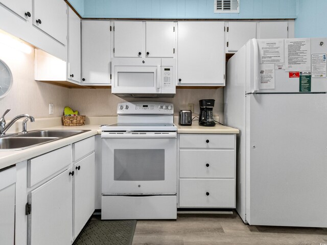 5000 N Ocean Blvd Unit B-1, North Myrtle Beach, SC 29582 - kitchen featuring white cabinets, a sink, light wood-style floors, white appliances, and visible vents