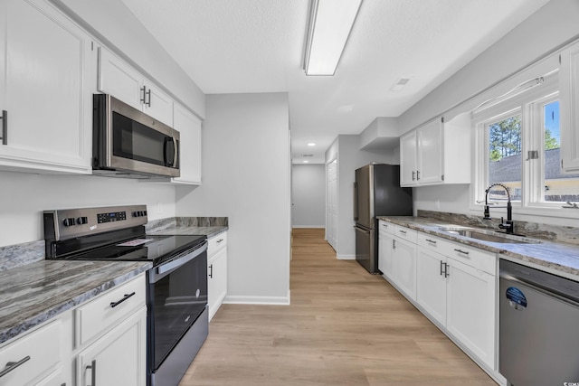 202 Berkshire Dr, Myrtle Beach, SC 29588 - kitchen featuring white cabinets, light stone countertops, stainless steel appliances, and a sink