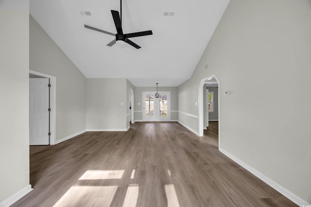202 Berkshire Dr, Myrtle Beach, SC 29588 - unfurnished living room with high vaulted ceiling, arched walkways, a ceiling fan, and visible vents