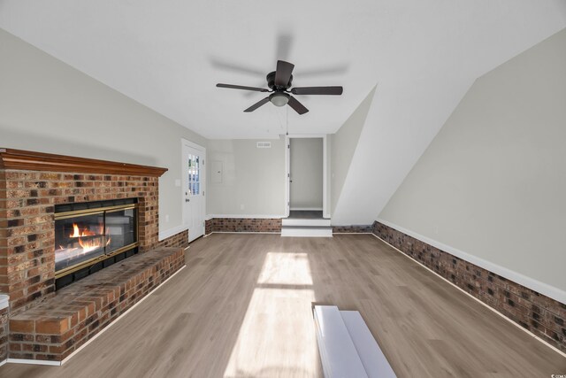 202 Berkshire Dr, Myrtle Beach, SC 29588 - unfurnished living room featuring a fireplace, wood finished floors, visible vents, and ceiling fan