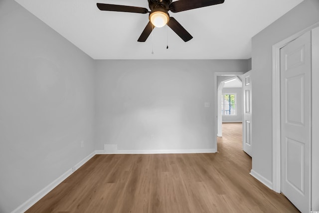 202 Berkshire Dr, Myrtle Beach, SC 29588 - empty room with arched walkways, wood finished floors, baseboards, and ceiling fan