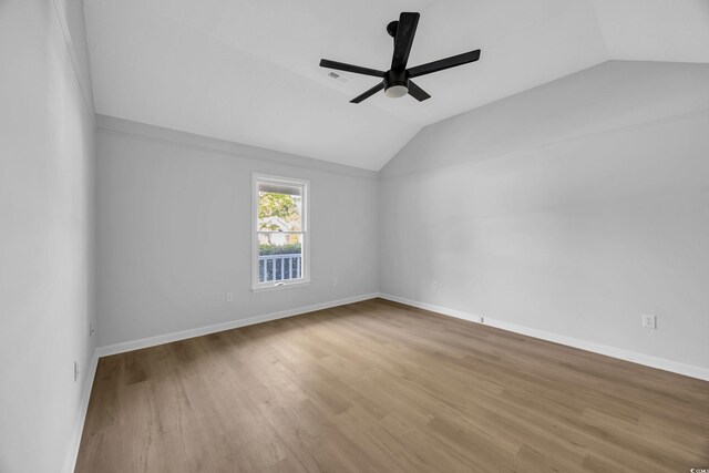 202 Berkshire Dr, Myrtle Beach, SC 29588 - spare room with lofted ceiling, baseboards, a ceiling fan, and wood finished floors